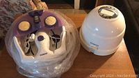 Photo showing Conair foot bath with scrubber attachments and Conair dome-style hair dryer side by side.
