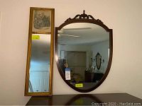 Both mirrors positioned side by side on a wall, showcasing their frames and sizes.