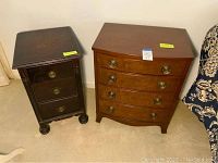 Photo showing two vintage wooden night stands placed side by side on a carpeted floor near a floral couch and white chair.