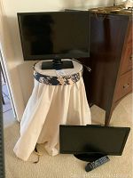 Samsung and Seiki 19 inch TVs displayed with the covered round stool.