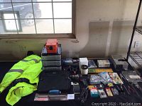 Wide view of all items showing Craftsman drill, jacket, clamps, organizer drawers, small hand tools and accessories