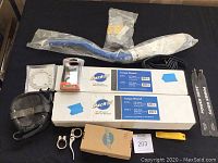Overview photo showing all items including torque wrenches in boxes, handlebar, grips, quick release clamps, pouch, and other accessories arranged on a table.
