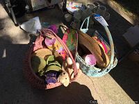 Set of seven woven baskets filled with various items including stuffed animals and hats.