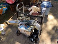 Top-down view of items showing crutches, walker, boxes, and foot spas under bright daylight outdoors