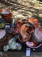 Assortment of over 15 copper and metal food molds including heart, fish, shell shapes and others displayed together.
