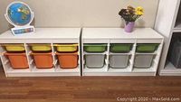 Front view of two white Ikea storage drawer units with colorful plastic bins.