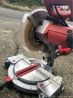 Side view of the 10 inch Skilsaw miter saw showing the blade, guard and base.