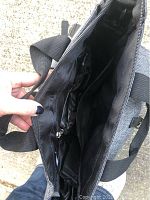 View inside the diaper bag showing multiple internal compartments and pockets.