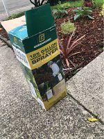 Photo of the cardboard box packaging for Greenwood 1.25 gallon home and garden sprayer, showing branding and product name.