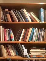 Three photos showing multiple shelves of assorted books including science, philosophy, history, politics, and music topics. Some vintage editions visible.