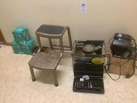 Photo showing a vintage metal two-step stool, original Black & Decker router box, router bit case with bits, and two battery chargers with cords.