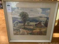 Framed watercolour painting showing rural landscape with farmhouse and trees under cloudy sky, signed by K. C. McClelland.