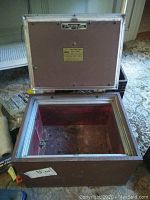 Open Hercules safe showing brown interior with silver trim and latch mechanism.