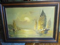 Full view of framed painting showing harbored ships on canvas with an ornate wood frame.