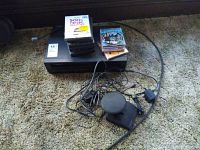 Photo of RCA VCR with assorted DVDs and tangled cords