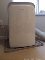 Front view of Brada portable air conditioner unit on plastic drip tray