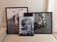 Three Marilyn Monroe black and white pictures grouped on floor, largest framed at 21.5x27.5 inches