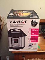Front view of the Instant Pot box showing the appliance and key features like 7-in-1 multi-use programmable pressure cooker.