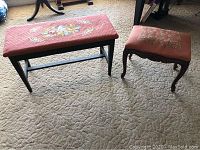 Overview of both needlepoint piano bench and ottoman on carpeted floor, showing upholstery and wooden legs