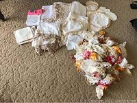 Lot of antique and vintage linens including embroidered and crocheted tablecloths, napkins, and numerous doilies