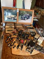 Full tabletop view of model cars and framed images