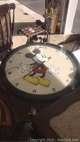 Full view of the round coffee table with Mickey Mouse clock face in sunlight.