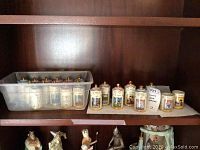Wooden shelf showing plastic tub of containers and additional jars arranged beside it