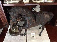 Large vintage brown horse statue with harness and two smaller horse statues