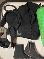 Photo showing black wetsuit jacket, neoprene hood, boots, XL gloves, and green scuba tank mesh cover.
