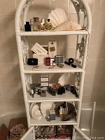Full view of the white wicker shelving unit with all displayed items