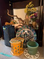 Overall arrangement of pottery, dried flowers, plant pot, ceramic containers, wood chest, and flower arranging frog.