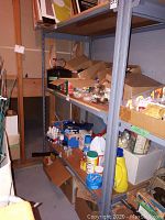 Metal shelving unit with assorted items on shelves to show size and construction.