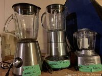 Photo showing 3 appliances side by side: Breville blender with glass pitcher, PC blender, and Cuisinart chopper, each labeled with capacity and working status.