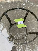 Top view of clear round glass tabletop with metal base visible beneath