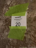 Photo of label taped to surface showing lot number 20