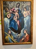 Full view of Madonna and Child painting with angels in ornate gold frame.