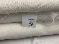 Close-up image of folded white mesh rolls showing semi-transparent woven texture and MaxSold auction tag.
