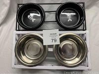 Top view showing black bowls with fishbone designs in black metal stand and stainless steel bowls in white tray.