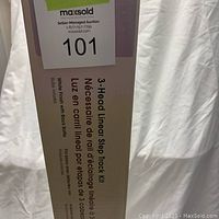 Photo of the unopened box with identification label and product details about the 3 Head Linear Step Track Kit