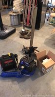 Full lot photo showing air compressor, battery charger, jacks, and a box