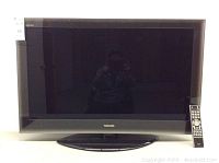 Front view of Toshiba 42 inch flat screen TV with remote placed on right side