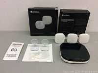 Main image showing Ecobee thermostat, three sensors, two suction mounts, manuals, and boxes.