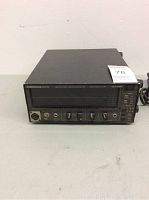 Front angle view of the black Audio Control Industrial Real Time Spectrum Analyzer showing input connectors, control knobs, and the display panel with surface wear.