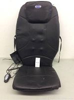 Full view of the Dr Scholls back massager mounted on chair with wired remote and surface wear visible.