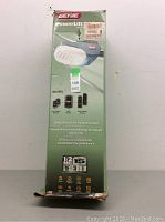 Front view of the boxed Genie PowerLift 900 garage door opener showing brand, product image, and included accessories.