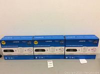 Three boxed Linksys kits showing front packaging highlighting the included router, range extender, and 24/7 tech support.