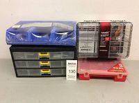 Front view of assorted plastic organized bins including black drawers with yellow handles, a clear Husky waterproof organizer, a red and clear box, and blue bins stacked on top.