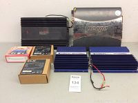 Front view showing all seven items: 2 Orion amplifiers, Processor Power amplifier, Vampire amplifier, and 3 boxed speaker components.