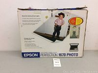 Original retail box for Epson Perfection 1670 Photo color scanner, showing front view with product image and description.