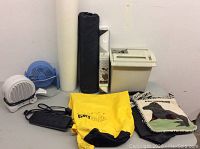 Full lot overview with all items arranged: yellow Dry Sack, blue fan, white heater, shredder, yoga mat rolled, black bag, dog design blanket.